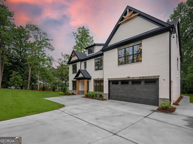4955 Chamblee Dunwoody Rd, Dunwoody, GA 30338 - view of front of property with driveway, a garage, a yard, and brick siding