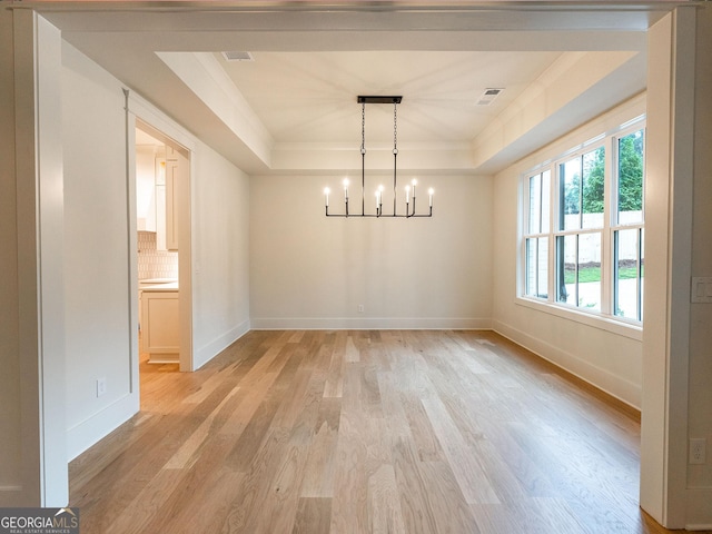 4955 Chamblee Dunwoody Rd, Dunwoody, GA 30338 - unfurnished dining area with a tray ceiling, a chandelier, light wood finished floors, and ornamental molding