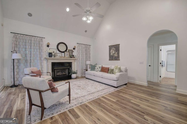 1488 Pleasant Hill Rd NE, Ranger, GA 30734 - living area featuring arched walkways, ceiling fan, wood finished floors, a fireplace, and baseboards