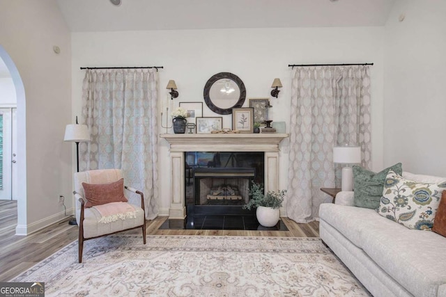 1488 Pleasant Hill Rd NE, Ranger, GA 30734 - living area with wood finished floors, arched walkways, a fireplace with flush hearth, and baseboards