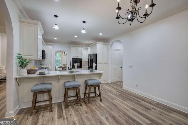 1488 Pleasant Hill Rd NE, Ranger, GA 30734 - kitchen with arched walkways, black oven, refrigerator, a peninsula, and crown molding