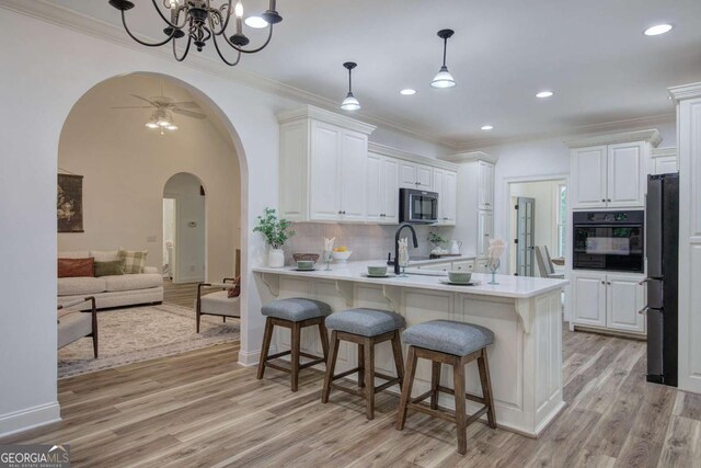 1488 Pleasant Hill Rd NE, Ranger, GA 30734 - kitchen with stainless steel appliances, arched walkways, light wood-style flooring, a peninsula, and recessed lighting