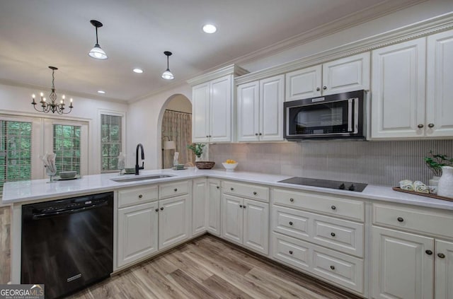 1488 Pleasant Hill Rd NE, Ranger, GA 30734 - kitchen with black appliances, a sink, arched walkways, a peninsula, and ornamental molding