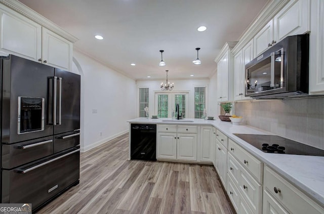 1488 Pleasant Hill Rd NE, Ranger, GA 30734 - kitchen with black appliances, a peninsula, white cabinets, a sink, and light wood-type flooring