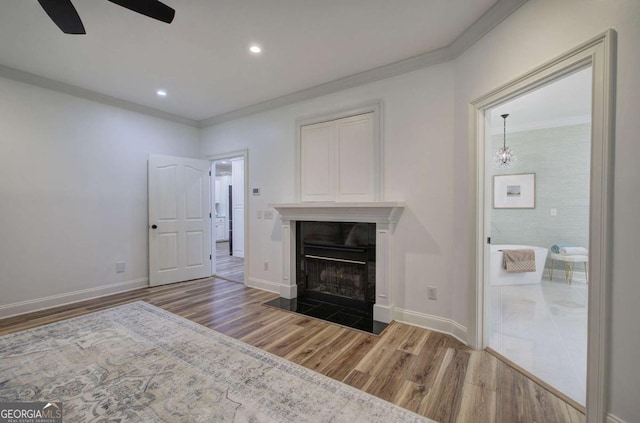 1488 Pleasant Hill Rd NE, Ranger, GA 30734 - unfurnished living room featuring wood finished floors, crown molding, a ceiling fan, a fireplace with flush hearth, and baseboards