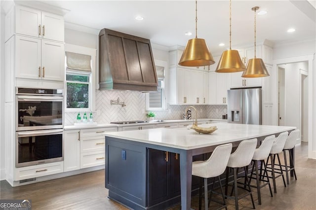 2602 Drew Valley Rd NE, Brookhaven, GA 30319 - kitchen featuring stainless steel appliances, decorative backsplash, custom range hood, dark wood-style flooring, and light countertops