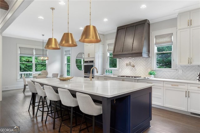 2602 Drew Valley Rd NE, Brookhaven, GA 30319 - kitchen with tasteful backsplash, a kitchen island with sink, stovetop, dark wood finished floors, and recessed lighting