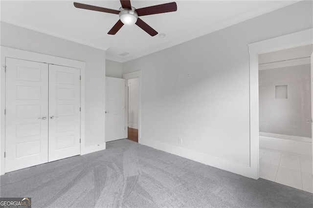 2602 Drew Valley Rd NE, Brookhaven, GA 30319 - unfurnished bedroom featuring carpet, a closet, ornamental molding, and ceiling fan