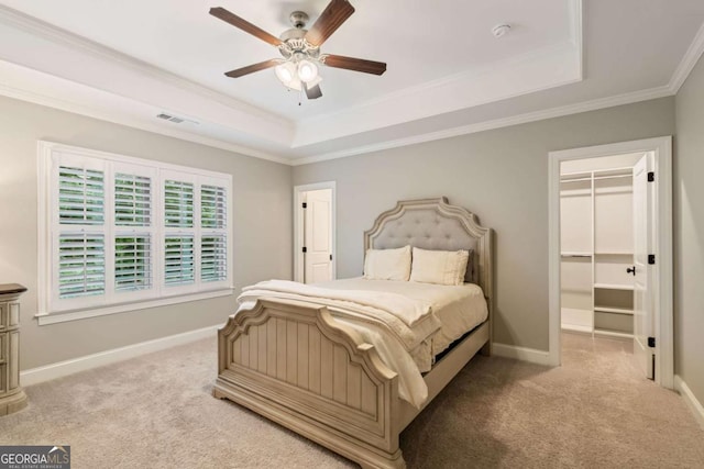 2377 Kesgrove Way, Buford, GA 30518 - bedroom featuring a raised ceiling, carpet floors, crown molding, a spacious closet, and ceiling fan