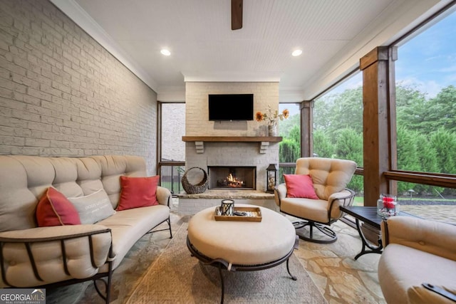 2377 Kesgrove Way, Buford, GA 30518 - living area with ornamental molding, a fireplace, brick wall, and recessed lighting