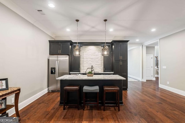 2377 Kesgrove Way, Buford, GA 30518 - kitchen featuring stainless steel fridge, a kitchen island, dark wood finished floors, light stone countertops, and a kitchen bar