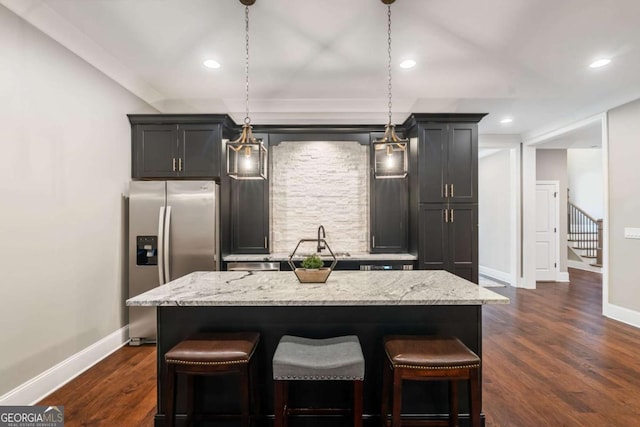 2377 Kesgrove Way, Buford, GA 30518 - kitchen featuring stainless steel fridge with ice dispenser, light stone counters, a kitchen breakfast bar, and recessed lighting
