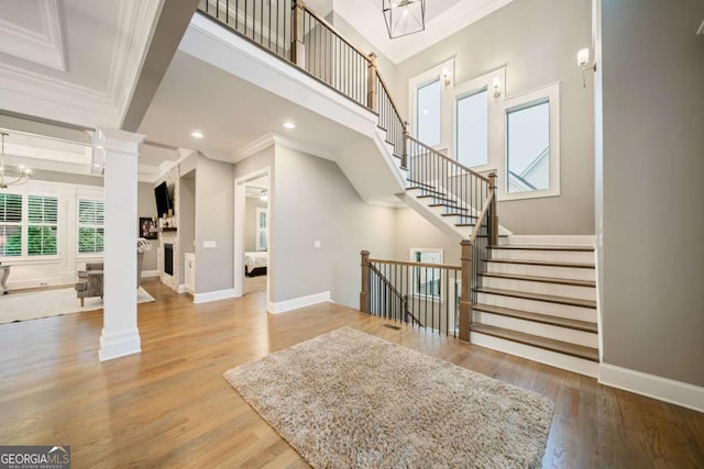 2377 Kesgrove Way, Buford, GA 30518 - foyer with ornamental molding, decorative columns, wood finished floors, stairway, and recessed lighting
