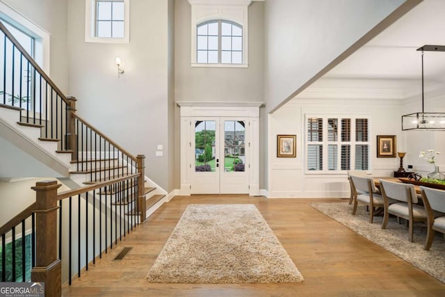 2377 Kesgrove Way, Buford, GA 30518 - entryway with a high ceiling, stairway, wood finished floors, and a chandelier