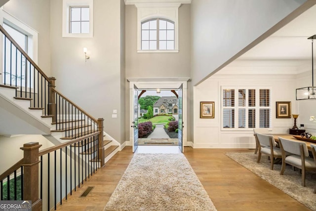 2377 Kesgrove Way, Buford, GA 30518 - entryway featuring a high ceiling, stairs, light wood-style flooring, and healthy amount of natural light