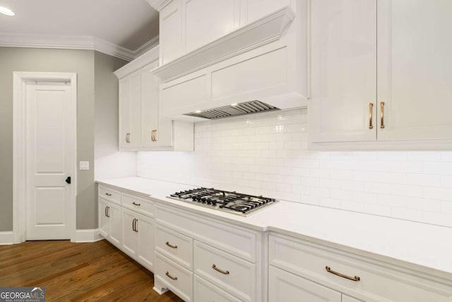 2377 Kesgrove Way, Buford, GA 30518 - kitchen with stainless steel gas stovetop, custom exhaust hood, light countertops, white cabinets, and ornamental molding