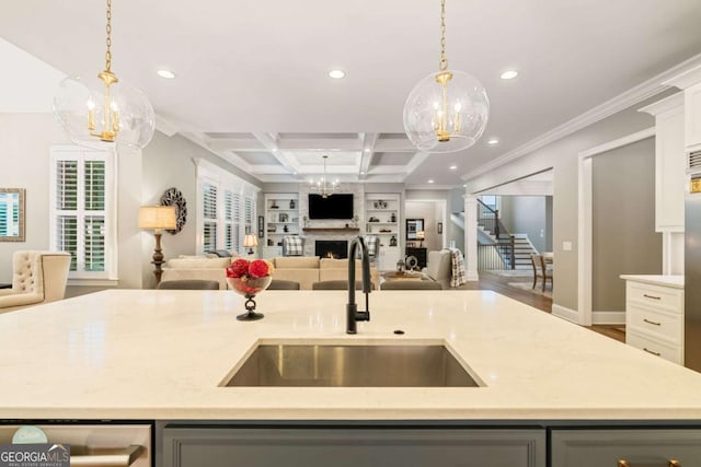 2377 Kesgrove Way, Buford, GA 30518 - kitchen featuring open floor plan, an island with sink, a chandelier, recessed lighting, and crown molding