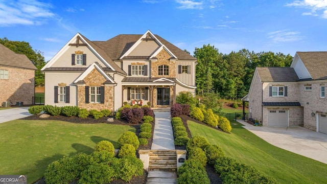 2377 Kesgrove Way, Buford, GA 30518 - craftsman house with stone siding, a standing seam roof, driveway, covered porch, and board and batten siding