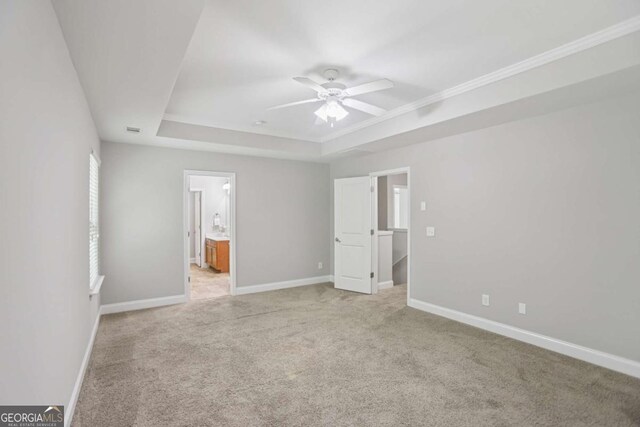 4546 Water Mill Dr, Buford, GA 30519 - unfurnished bedroom with a raised ceiling, light colored carpet, ensuite bath, ceiling fan, and crown molding