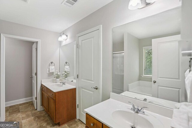 4546 Water Mill Dr, Buford, GA 30519 - bathroom with two vanities, a shower, and stone finish flooring