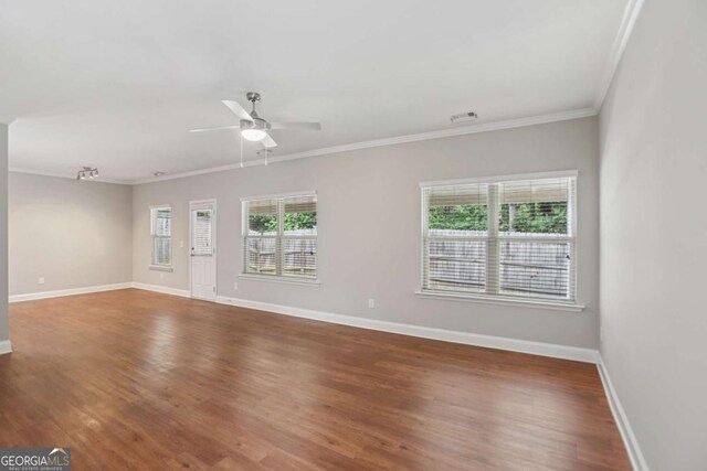 4546 Water Mill Dr, Buford, GA 30519 - unfurnished living room with wood finished floors, ornamental molding, and a ceiling fan