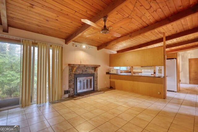 749 Dogwood Dr, Lawrenceville, GA 30046 - unfurnished living room featuring wood ceiling with exposed beams, light tile patterned floors, a ceiling fan, and a stone fireplace