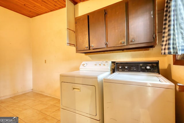 749 Dogwood Dr, Lawrenceville, GA 30046 - laundry area featuring washer and clothes dryer, cabinet space, wood ceiling, light tile patterned floors, and baseboards