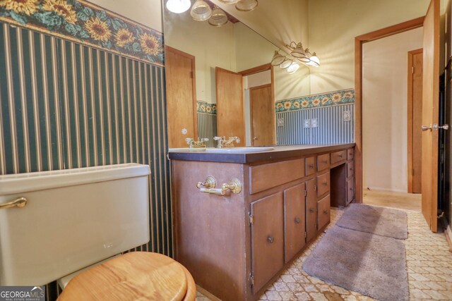 749 Dogwood Dr, Lawrenceville, GA 30046 - bathroom featuring wallpapered walls, a wainscoted wall, and vanity