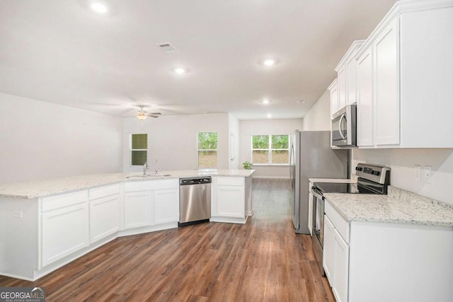 225 Limestone Cir, Conyers, GA 30013 - kitchen with appliances with stainless steel finishes, dark wood-style floors, a ceiling fan, white cabinets, and recessed lighting