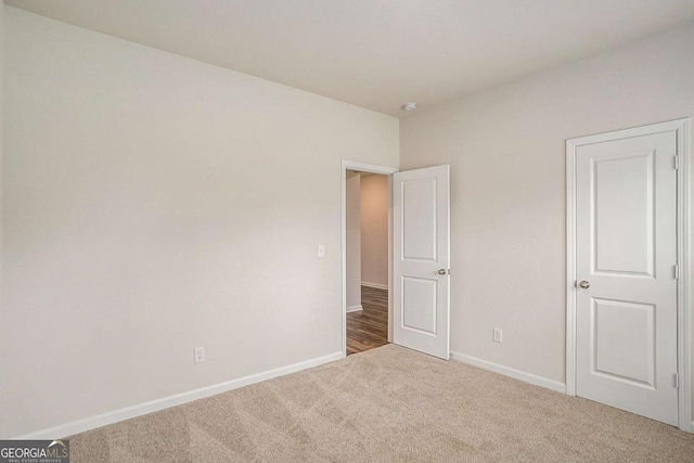 225 Limestone Cir, Conyers, GA 30013 - unfurnished bedroom featuring carpet flooring and baseboards