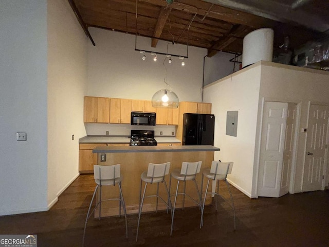 320 Martin Luther King Jr Dr SE Unit 5, Atlanta, GA 30312 - kitchen featuring black appliances, a towering ceiling, electric panel, light brown cabinetry, and a kitchen breakfast bar