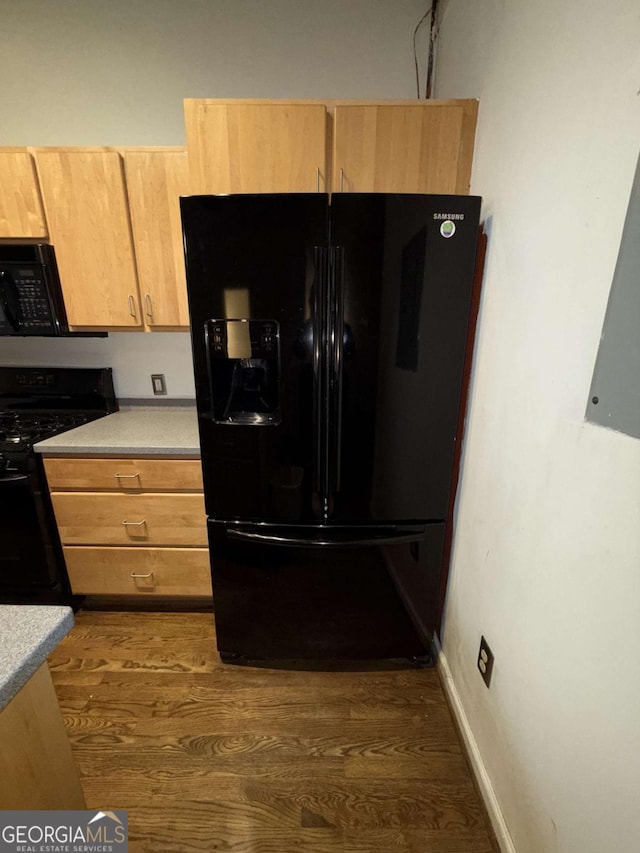 320 Martin Luther King Jr Dr SE Unit 5, Atlanta, GA 30312 - kitchen with black appliances, dark wood finished floors, light countertops, and baseboards