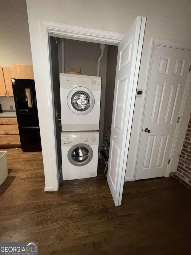 320 Martin Luther King Jr Dr SE Unit 5, Atlanta, GA 30312 - washroom with stacked washer and clothes dryer and dark wood-type flooring
