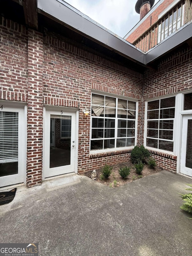 320 Martin Luther King Jr Dr SE Unit 5, Atlanta, GA 30312 - view of exterior entry with brick siding and a patio
