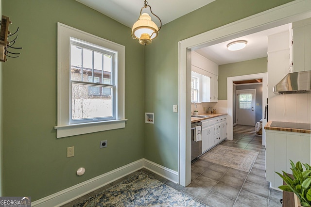 1391 Jefferson Ave, East Point, GA 30344 - kitchen featuring range hood, white cabinets, a sink, black electric cooktop, and baseboards