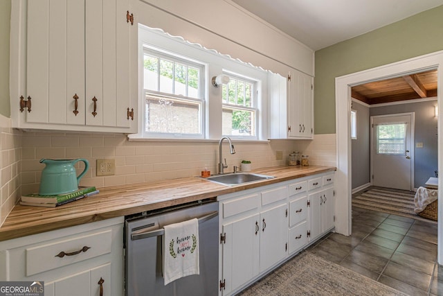 1391 Jefferson Ave, East Point, GA 30344 - kitchen with stainless steel dishwasher, wood counters, a sink, white cabinets, and decorative backsplash