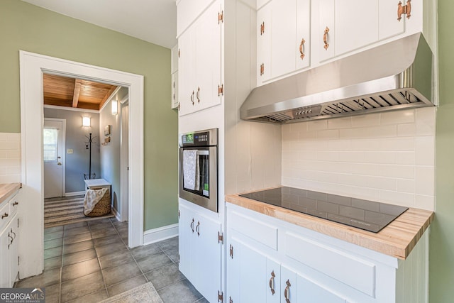1391 Jefferson Ave, East Point, GA 30344 - kitchen with oven, under cabinet range hood, black electric stovetop, decorative backsplash, and white cabinets