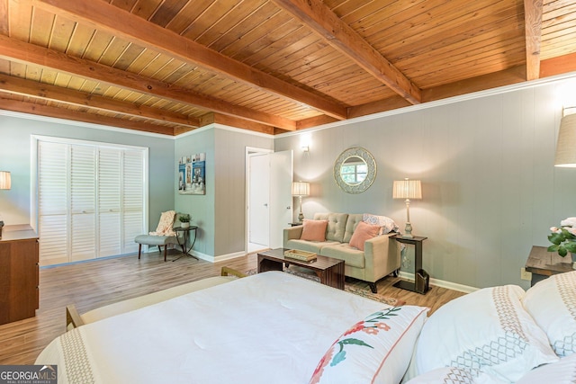 1391 Jefferson Ave, East Point, GA 30344 - bedroom with wood ceiling with exposed beams, wood finished floors, baseboards, a closet, and wooden walls