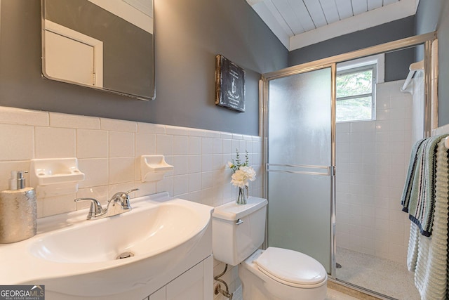 1391 Jefferson Ave, East Point, GA 30344 - full bathroom with a stall shower, toilet, tile walls, vanity, and wainscoting