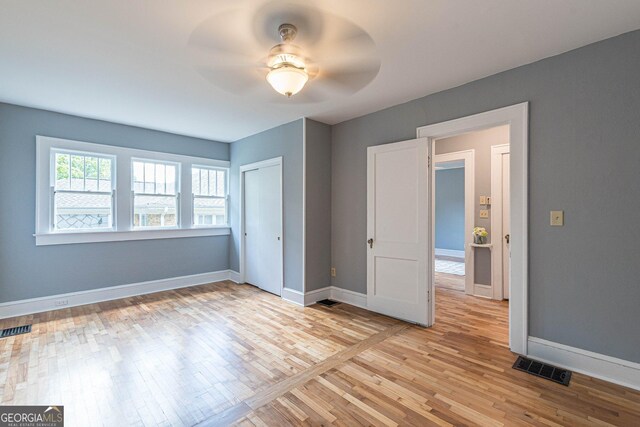 1391 Jefferson Ave, East Point, GA 30344 - unfurnished bedroom featuring light wood-style flooring, baseboards, a closet, and ceiling fan