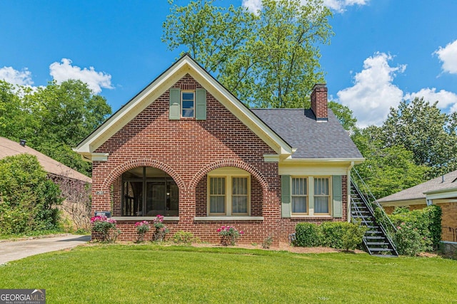 1391 Jefferson Ave, East Point, GA 30344 - view of front of property with brick siding, a chimney, stairs, and a front yard