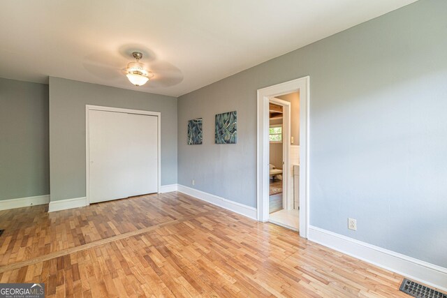 1391 Jefferson Ave, East Point, GA 30344 - unfurnished bedroom with wood finished floors, baseboards, a closet, and ceiling fan