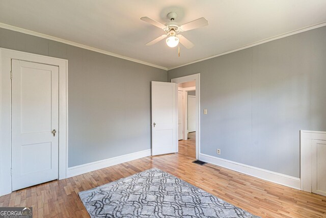1391 Jefferson Ave, East Point, GA 30344 - unfurnished bedroom featuring wood finished floors, baseboards, crown molding, and ceiling fan