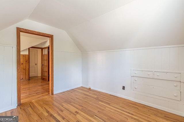 1391 Jefferson Ave, East Point, GA 30344 - bonus room with light wood-style floors, vaulted ceiling, and a wainscoted wall