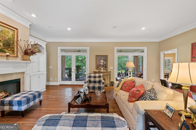 100 S Haven Ct, Macon, GA 31210 - living room with a tile fireplace, wood finished floors, crown molding, french doors, and plenty of natural light