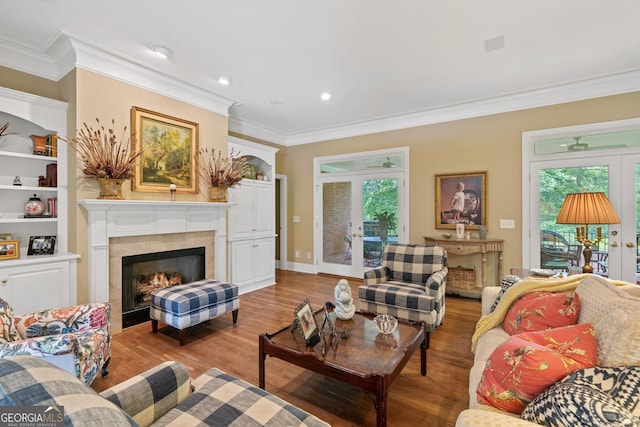 100 S Haven Ct, Macon, GA 31210 - living area featuring french doors, wood finished floors, ornamental molding, a tile fireplace, and healthy amount of natural light