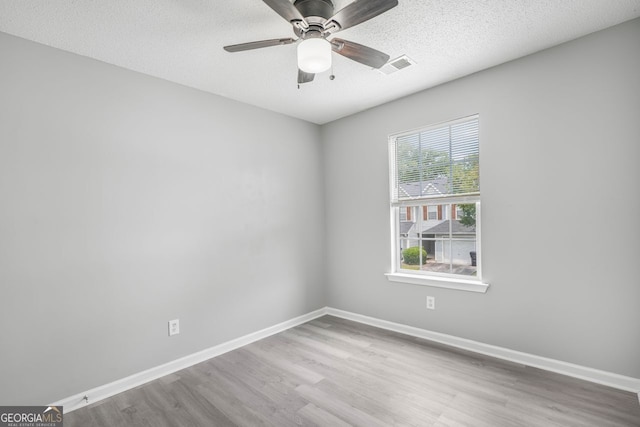 6947 Gallant Cir Unit 10, Mableton, GA 30126 - spare room featuring wood finished floors, ceiling fan, baseboards, and a textured ceiling