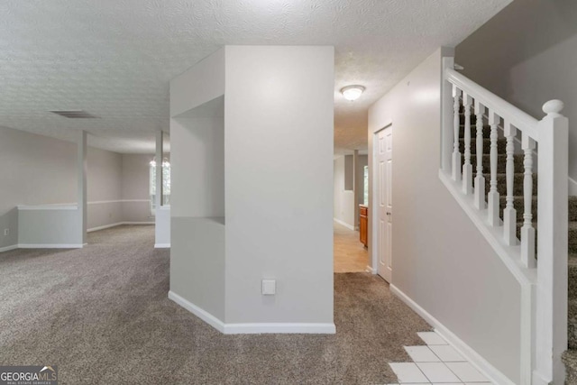 2191 Phillips Rd, Lithonia, GA 30058 - hallway featuring carpet floors, a textured ceiling, baseboards, and stairway