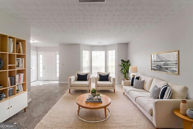 2191 Phillips Rd, Lithonia, GA 30058 - living area featuring carpet, a textured ceiling, and baseboards