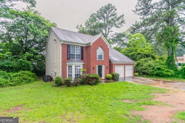 2191 Phillips Rd, Lithonia, GA 30058 - colonial-style house featuring an attached garage, driveway, a front lawn, brick siding, and central AC unit
